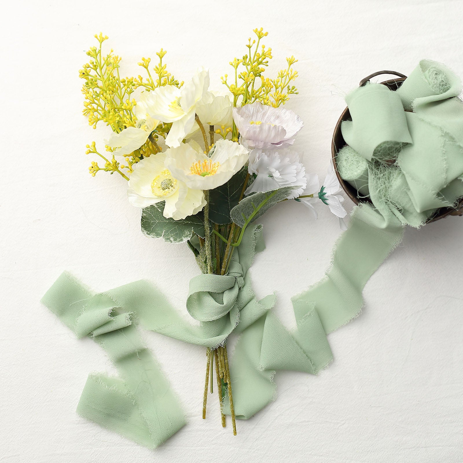 Sage green chiffon ribbon roll with DIY wedding bouquet accents.