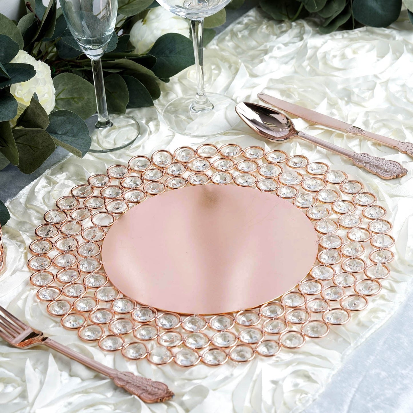Rose gold acrylic crystal beaded charger plate on a decorative table setting.