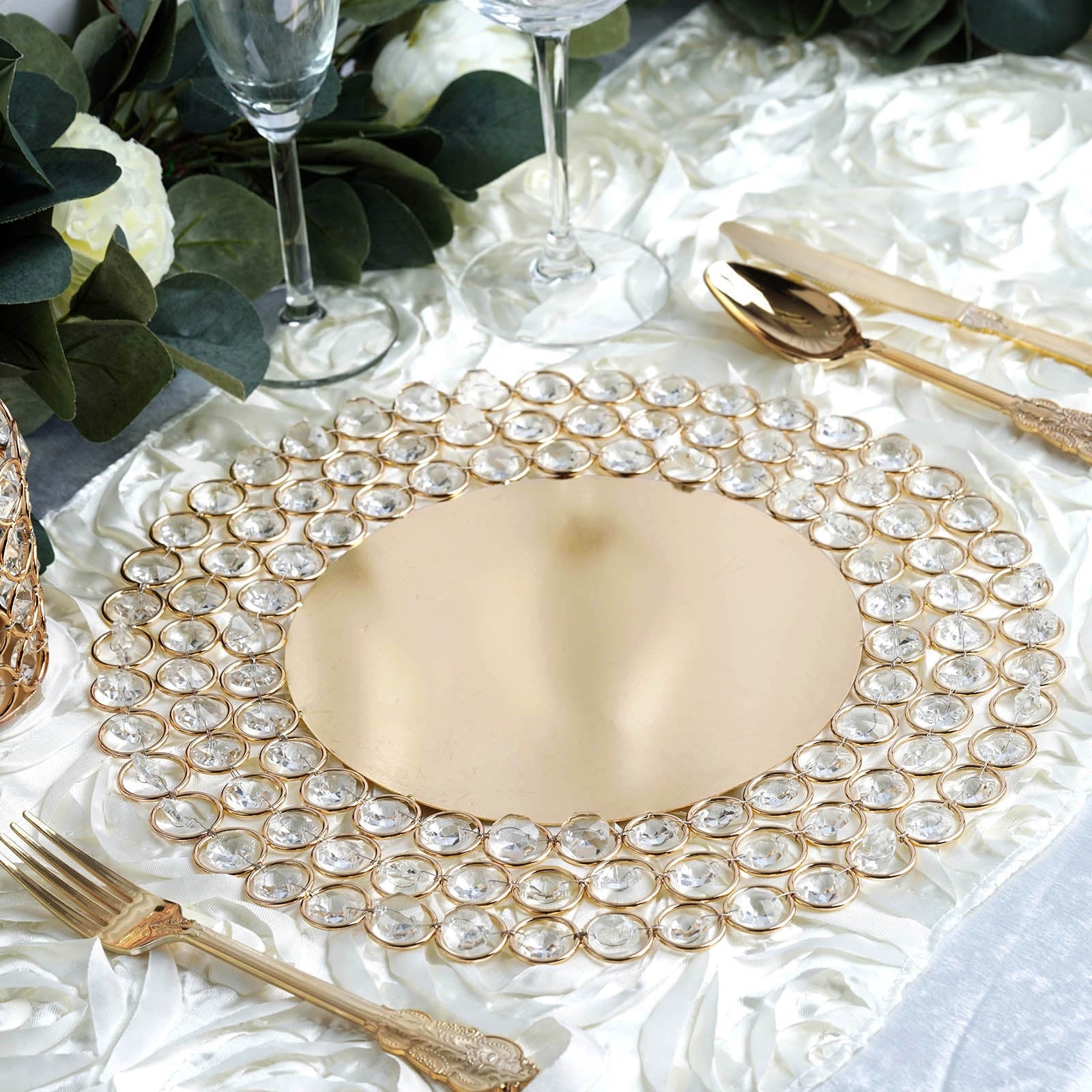 Gold beaded charger plate with acrylic crystals on a decorative table setting.
