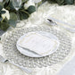 Silver beaded charger plate on a decorative table setting.