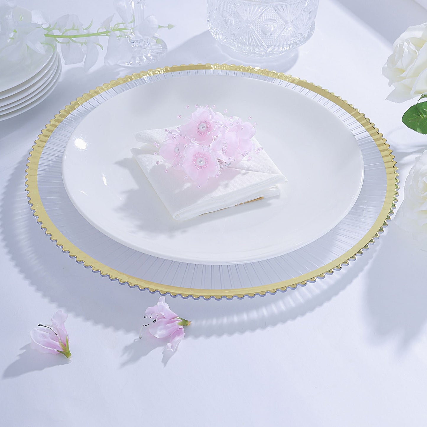 Clear wavy gold rim acrylic charger plate with white interior, elegant dining display.