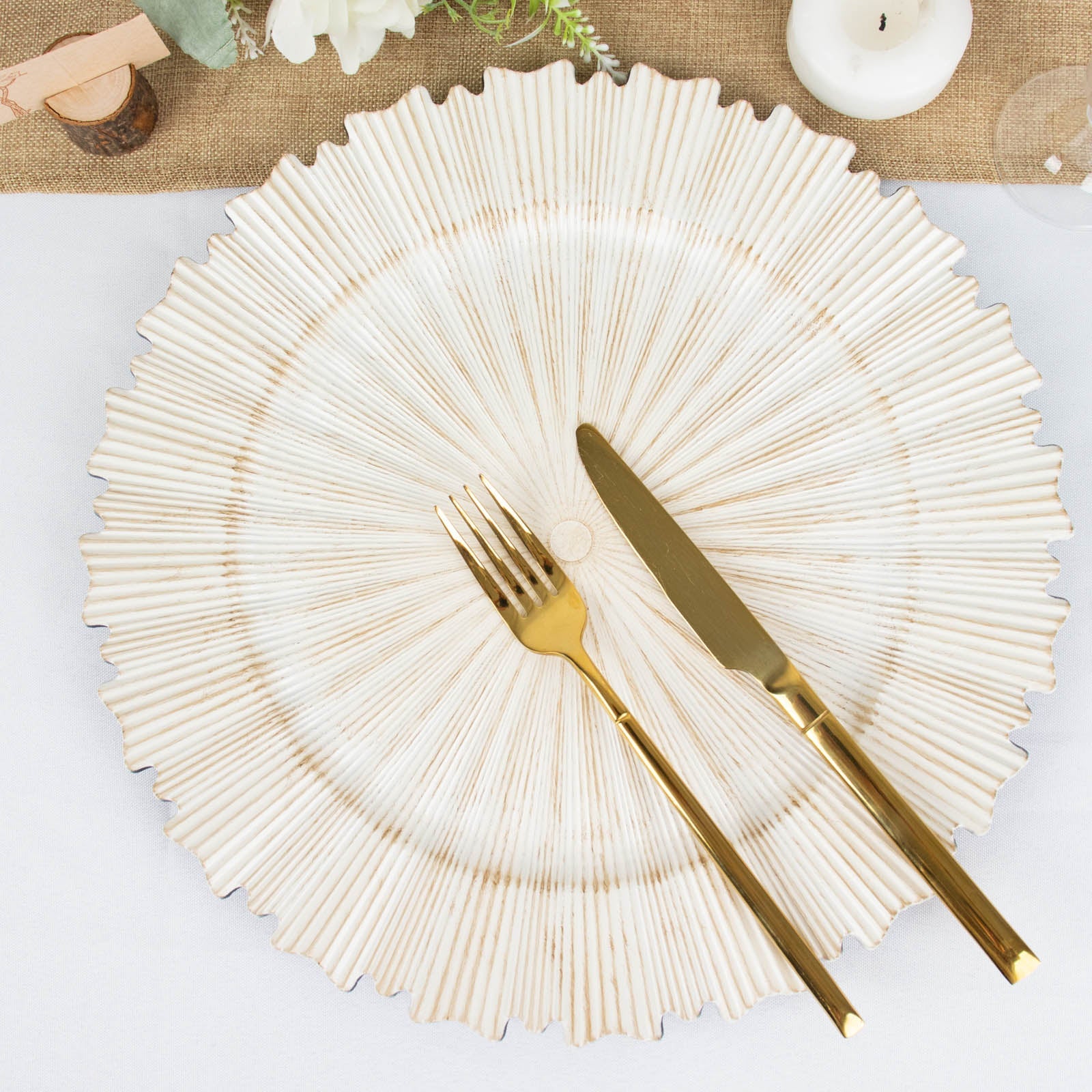 Antique white round charger plate with sunray scalloped rim.