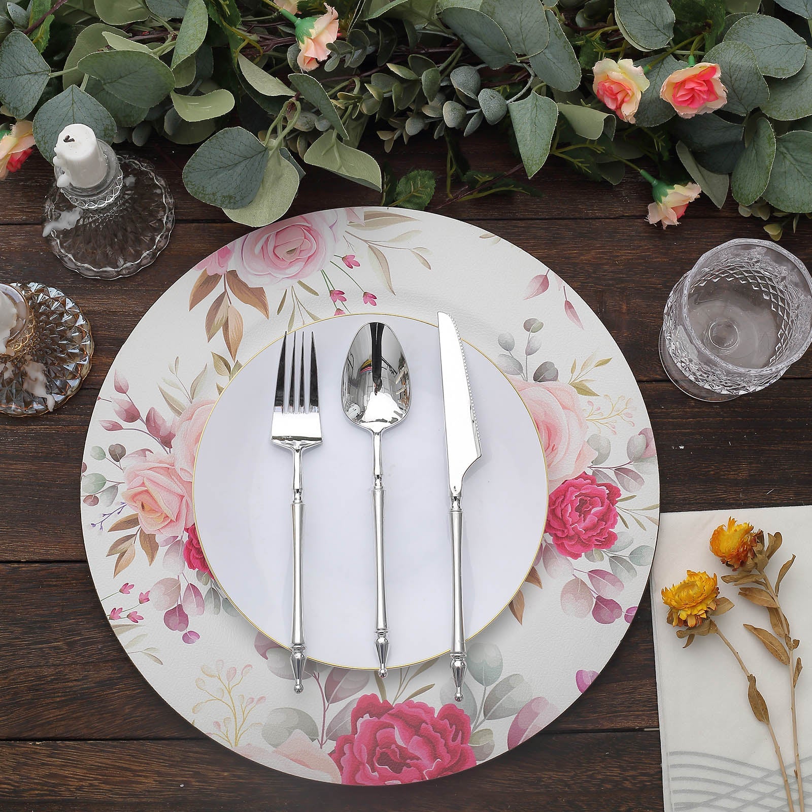 Rose floral design disposable serving plate with silver utensils.