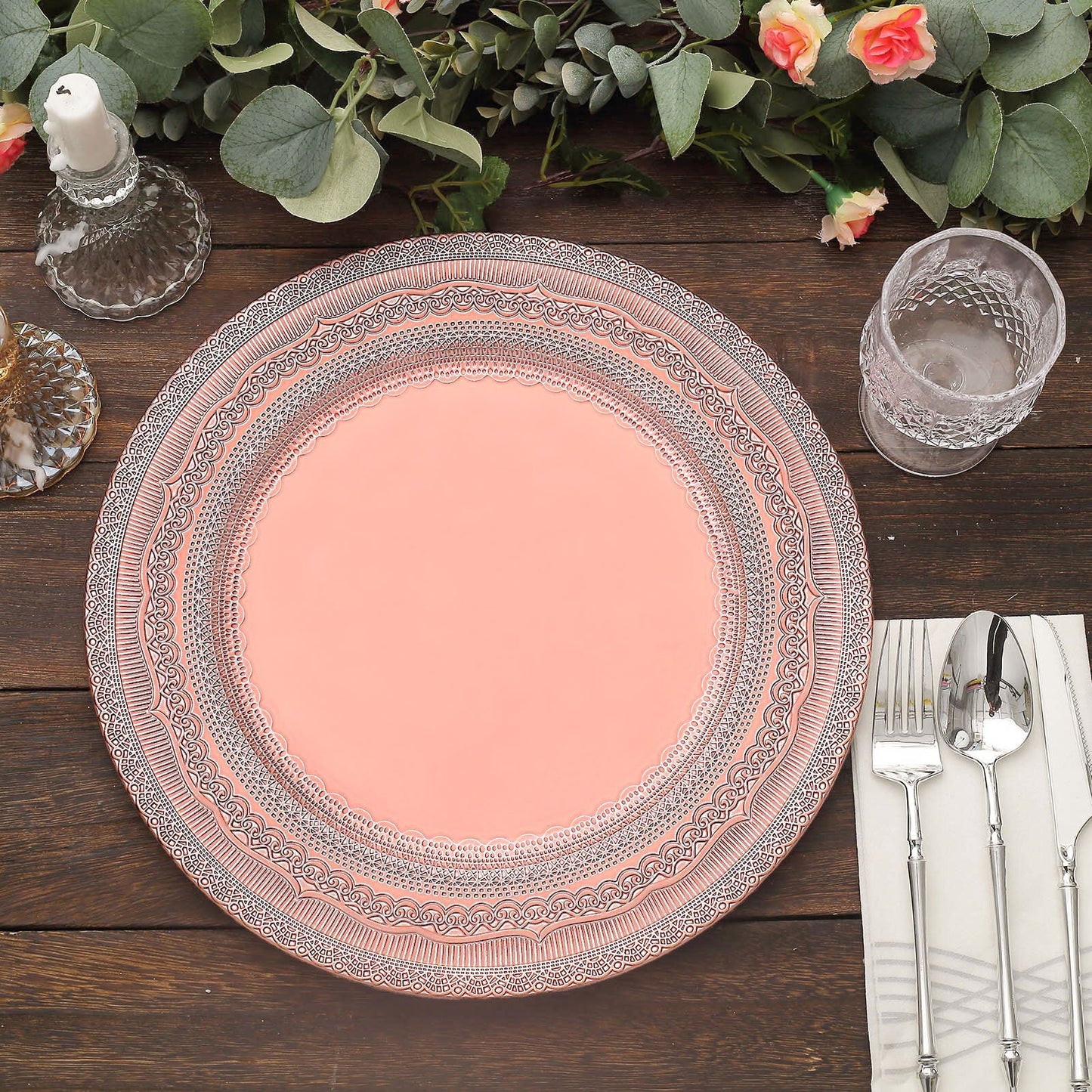 Rose gold rustic lace embossed acrylic charger plate on a wooden table.