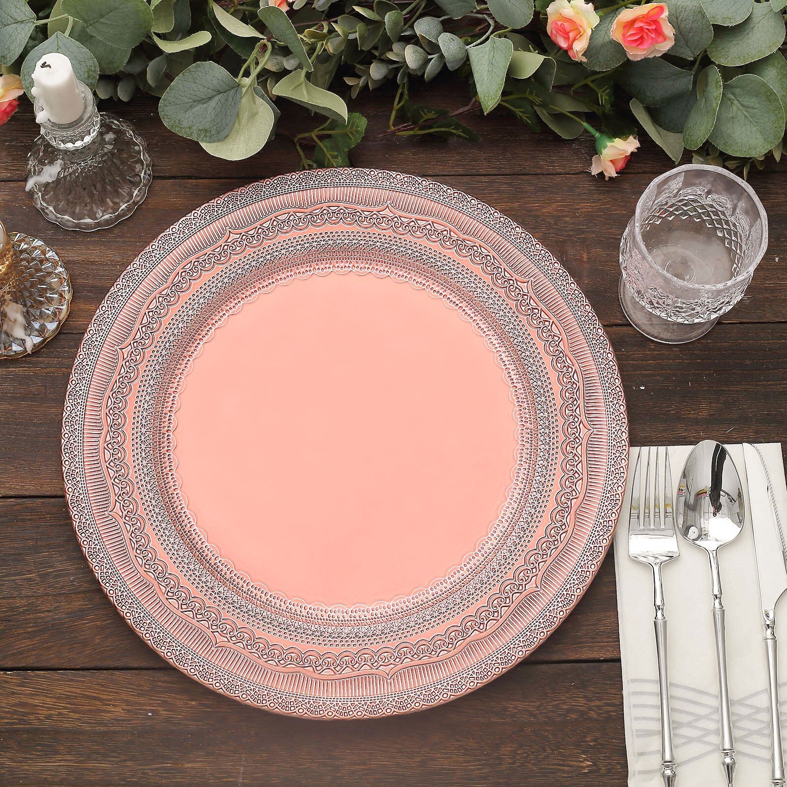 Rose gold rustic lace embossed acrylic charger plate on a wooden table.