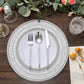 Silver rustic lace embossed acrylic charger plates on a wooden table.