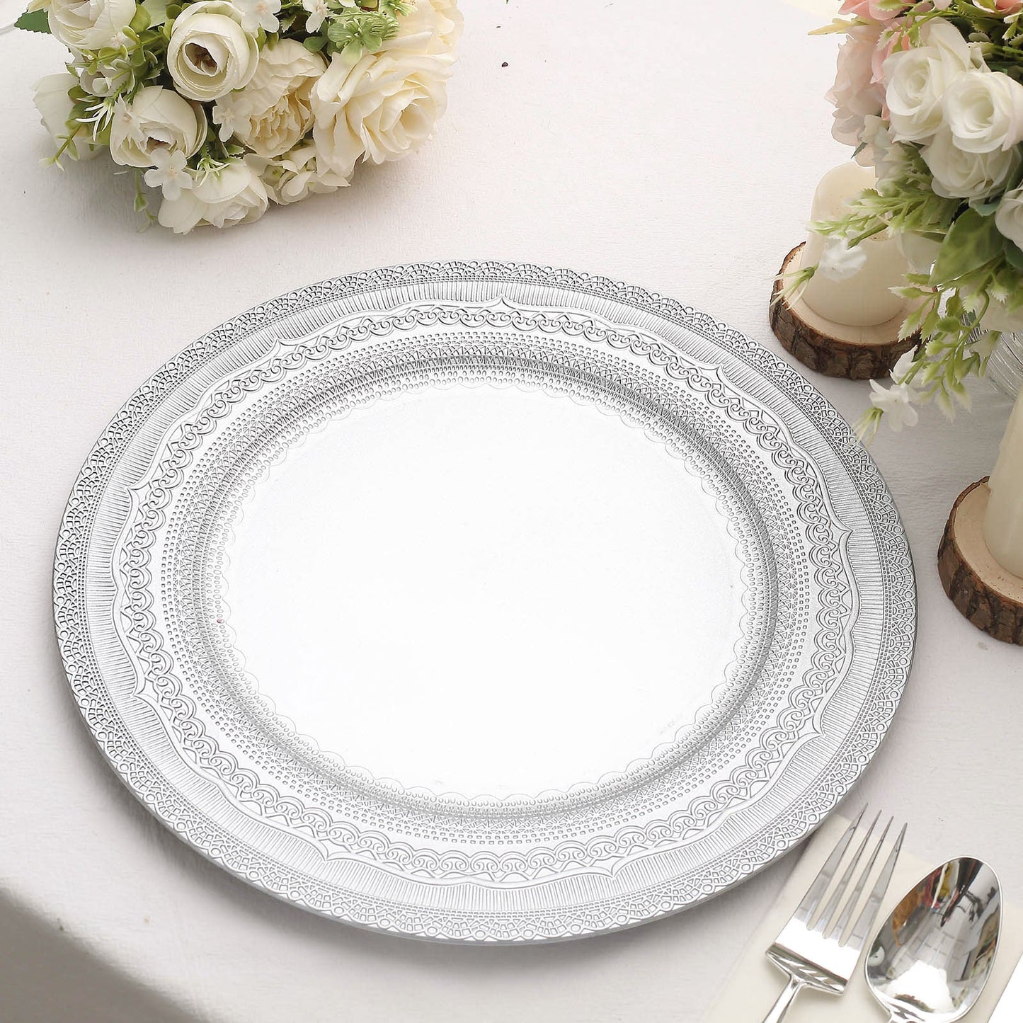Silver rustic lace embossed acrylic charger plate on a table setting.