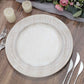 Elegant white decorative plate on a rustic wooden table with candles and flowers.