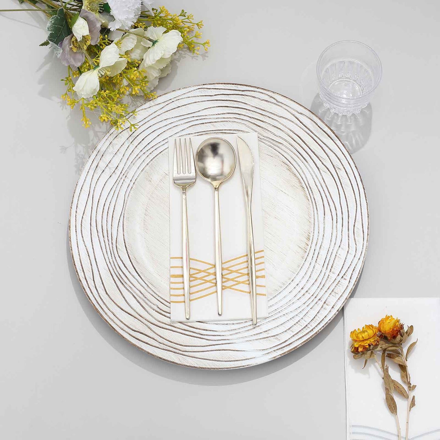 White washed round disposable charger plate with embossed design.