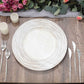 White washed round faux wood charger tray on a rustic table setting.