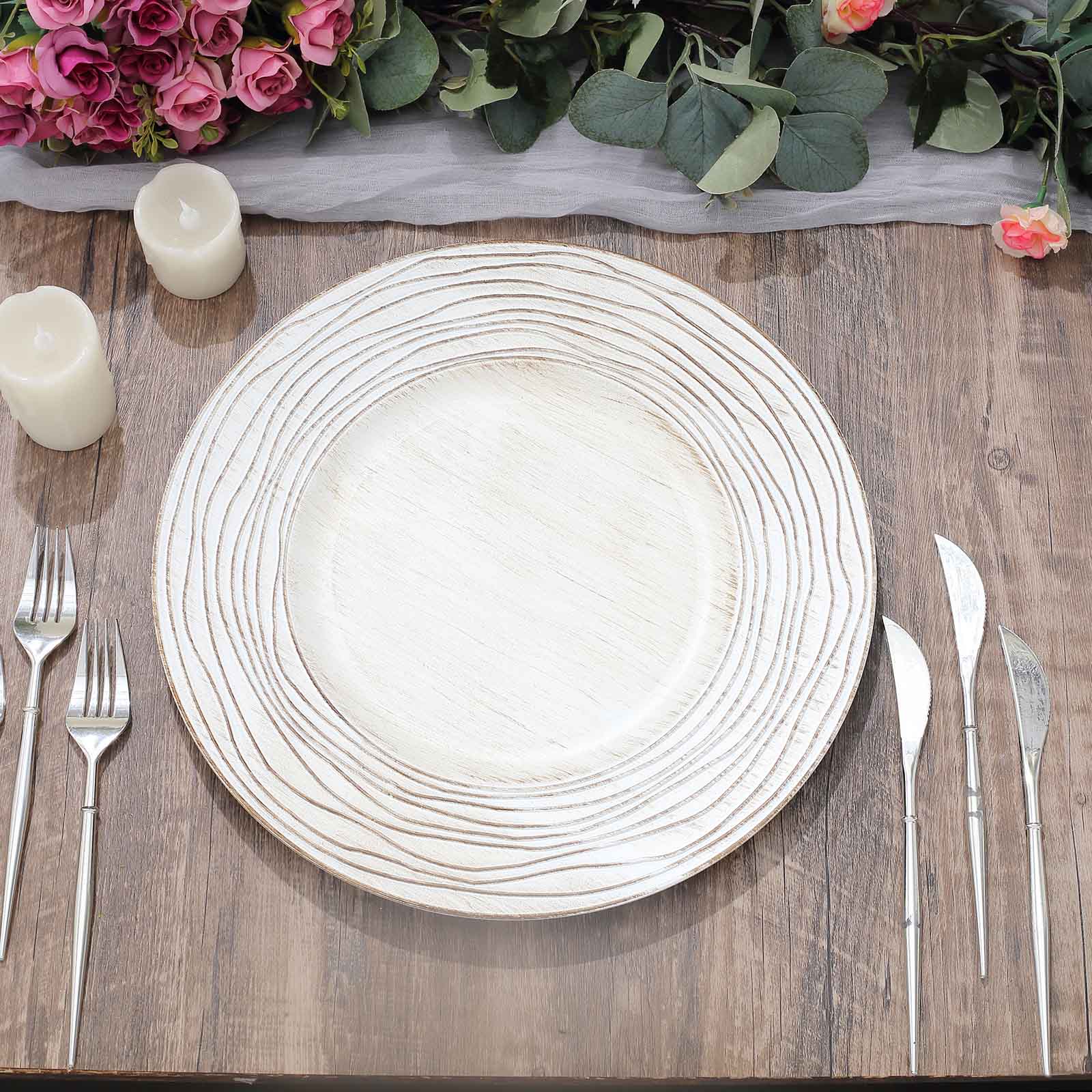 White washed round faux wood charger tray on a rustic table setting.