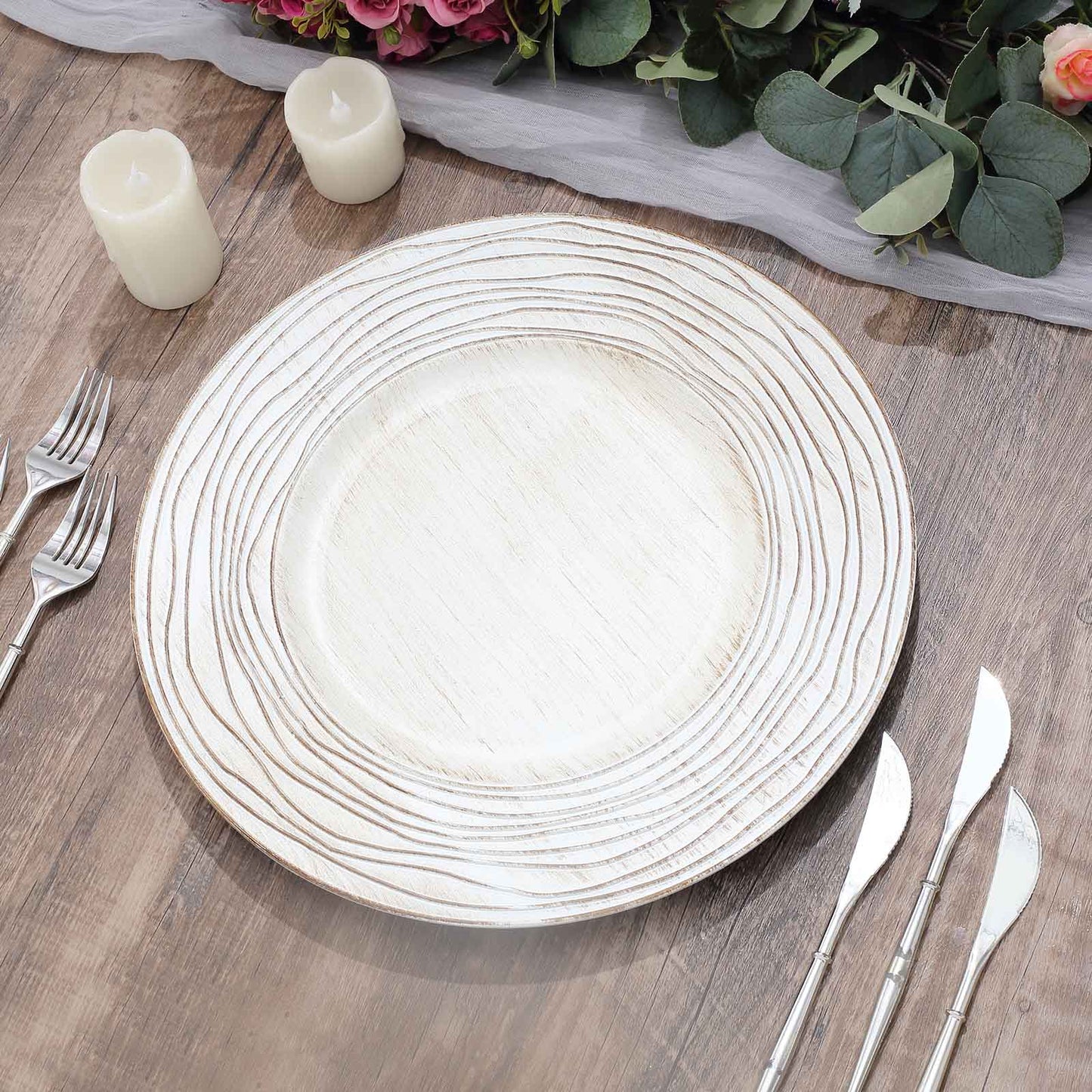 White washed embossed faux wood charger tray on a wooden table.