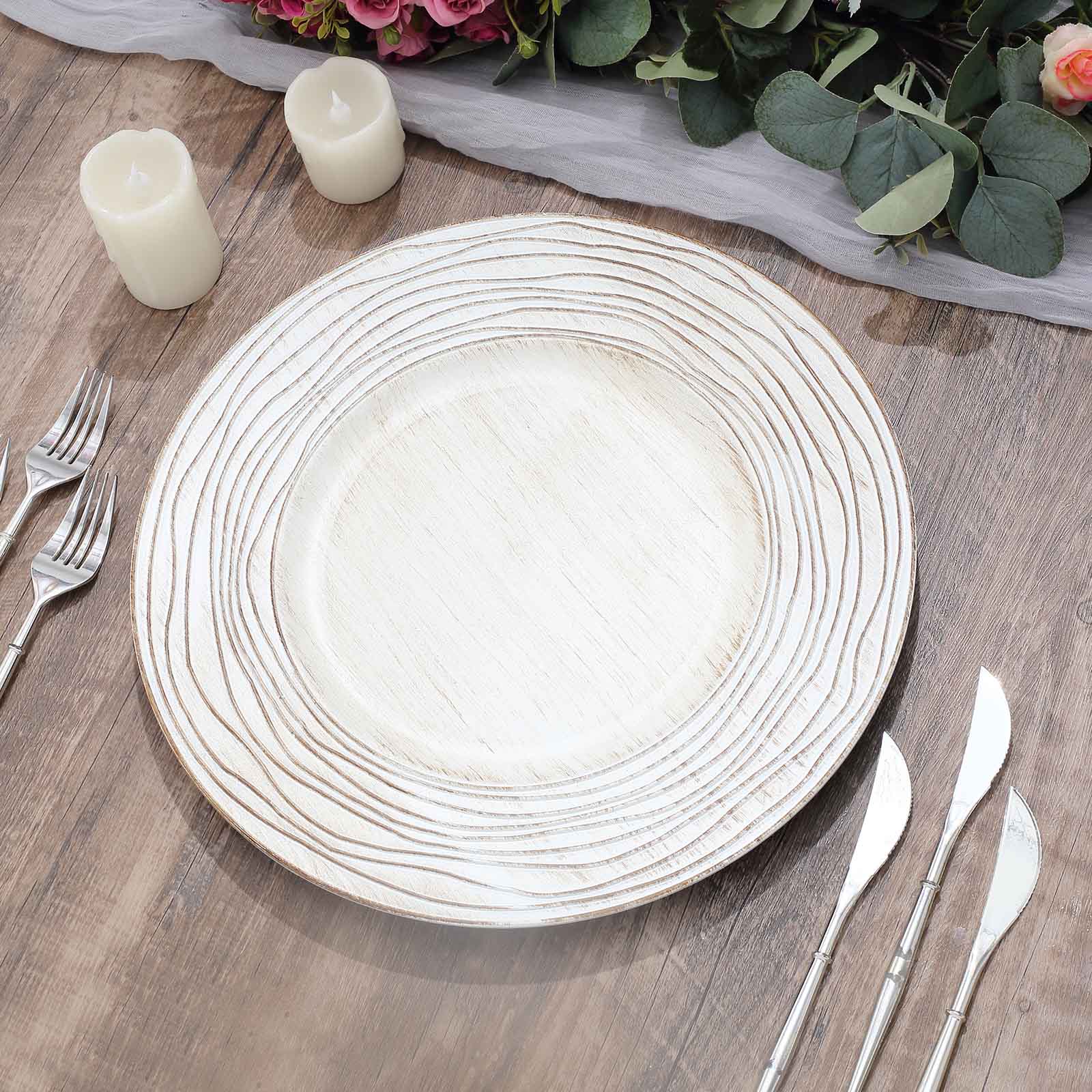 White washed embossed faux wood charger tray on a wooden table.