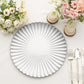 Silver scalloped shell pattern plastic charger plate on a table setting.