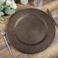 Natural brown rattan-like disposable round charger plate on a wooden table.