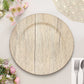 Natural wood grain plate on a table with flowers and dining utensils.