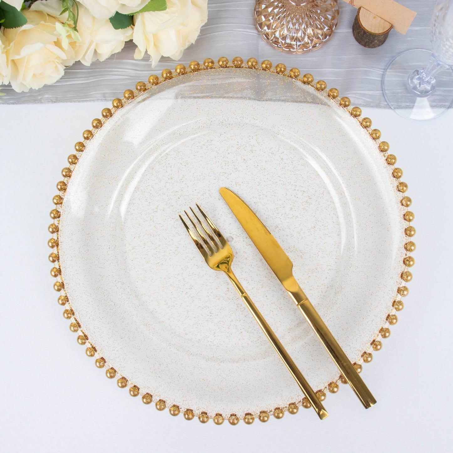 Clear gold glitter charger plate with beaded rim, perfect for elegant table settings.
