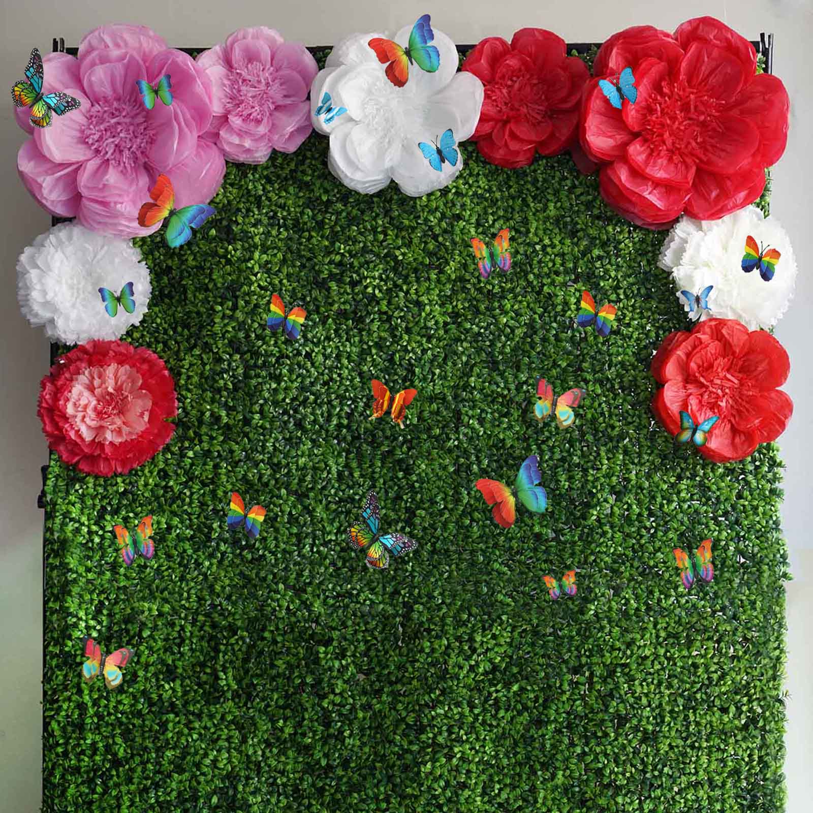 Pink butterfly wall decals on a green backdrop with floral decorations.
