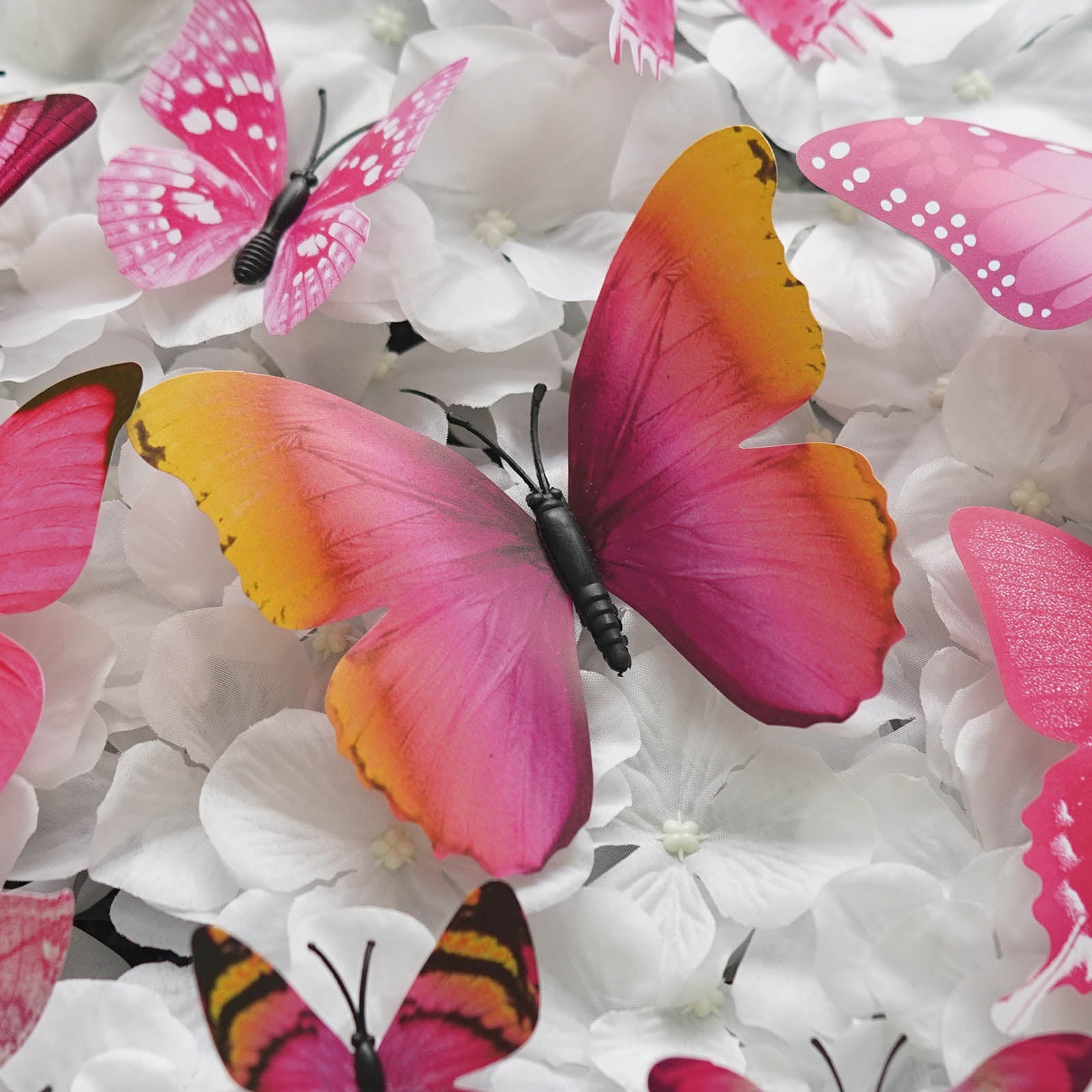 Pink butterfly wall decals on a floral background, 12 pack DIY decor.