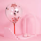 Rose gold round foil metallic confetti with balloon decor on a pink background.