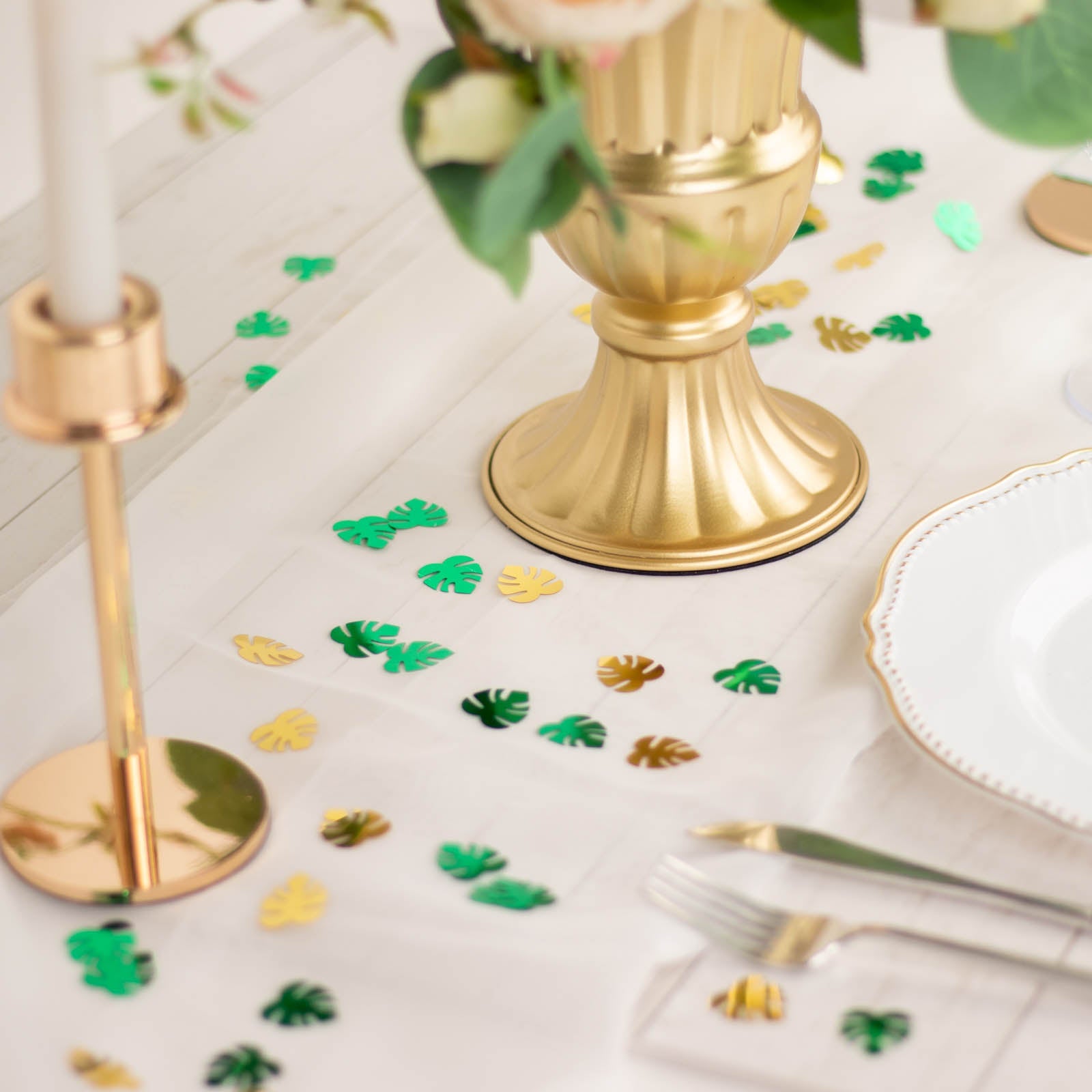 Metallic green and gold tropical palm leaf table confetti scatter.