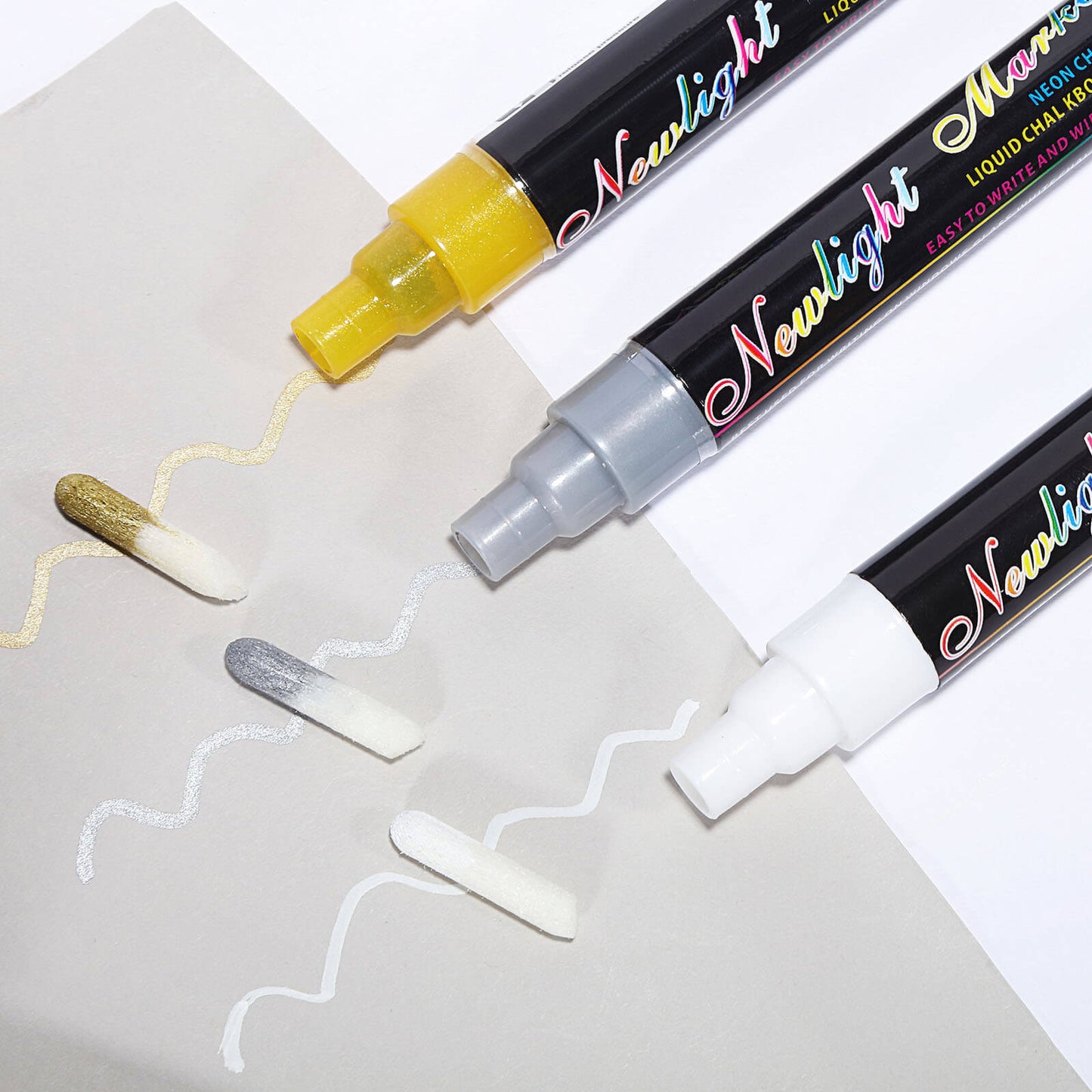 Erasable liquid chalk markers in yellow, gray, and white on a light background.