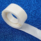 Clear adhesive dots for balloon arches on a blue background.