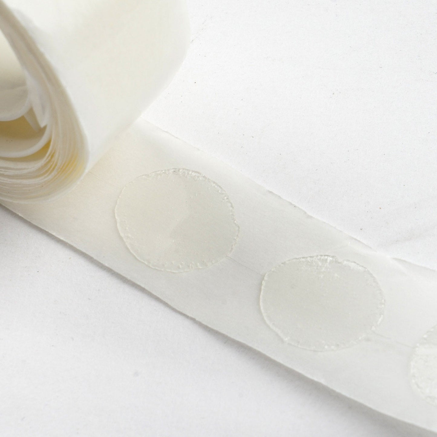 Clear removable balloon arch glue dots on a roll. #whtbkgd