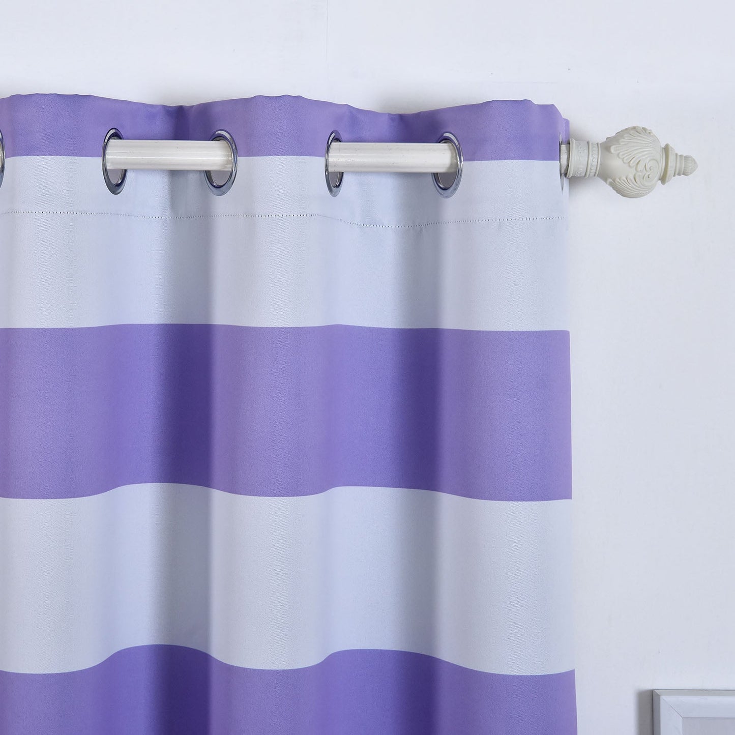 White and lavender striped thermal blackout curtains with chrome grommets.