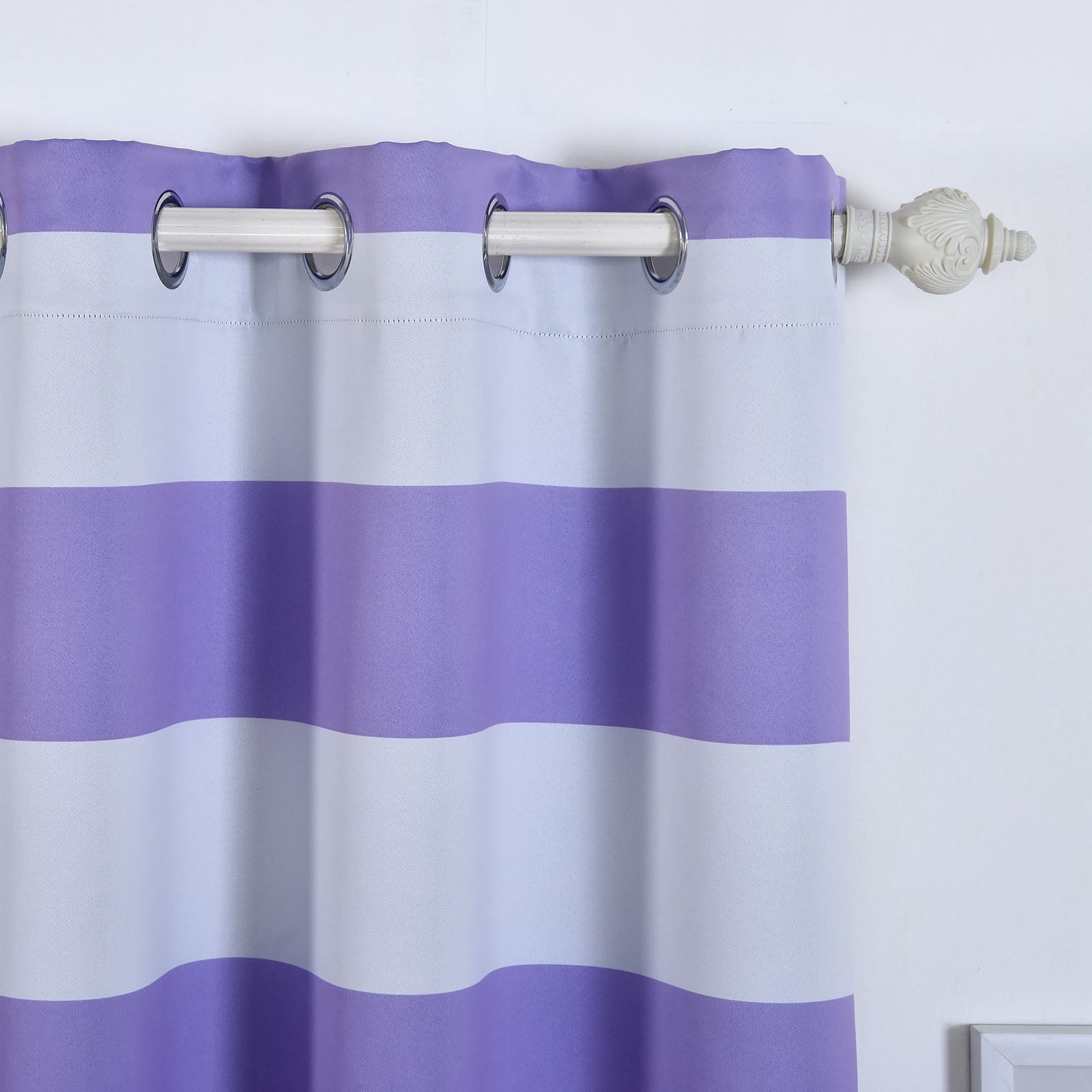 White and lavender striped thermal blackout curtains with chrome grommets.