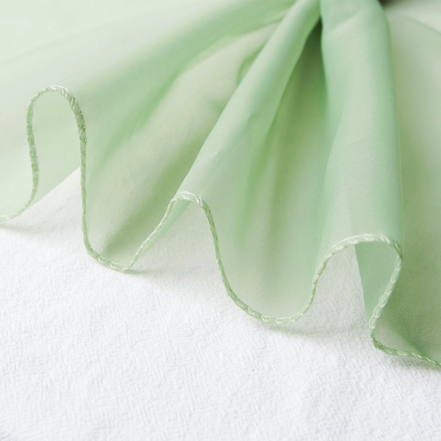Sage green chiffon curtain panel with a soft, flowing drape.
