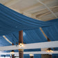 Navy blue chiffon curtain panel draping elegantly from the ceiling.