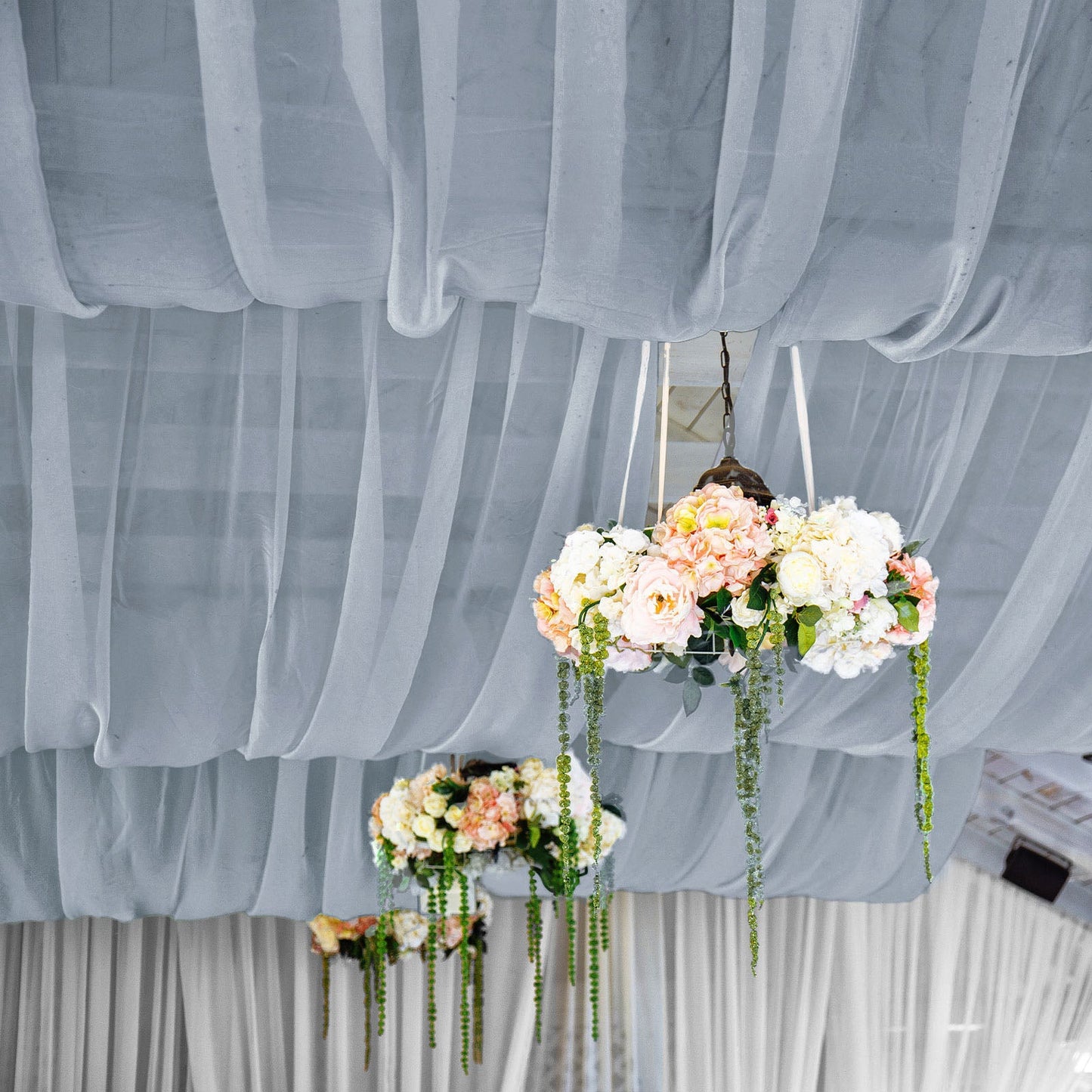 Dusty blue chiffon curtain panel draping elegantly with floral decorations.