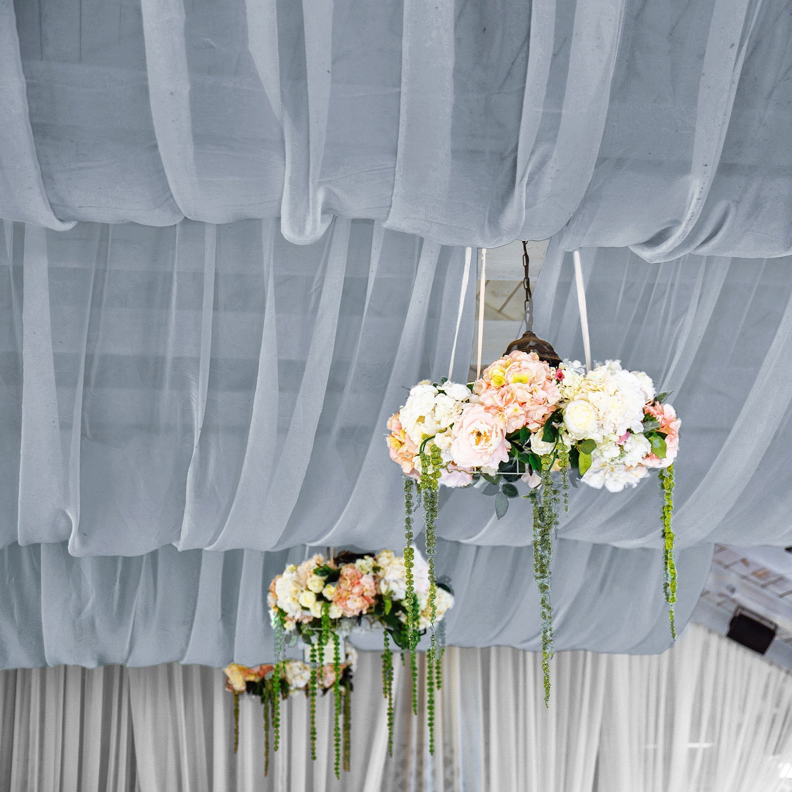 Dusty blue chiffon curtain panel draping elegantly with floral decorations.
