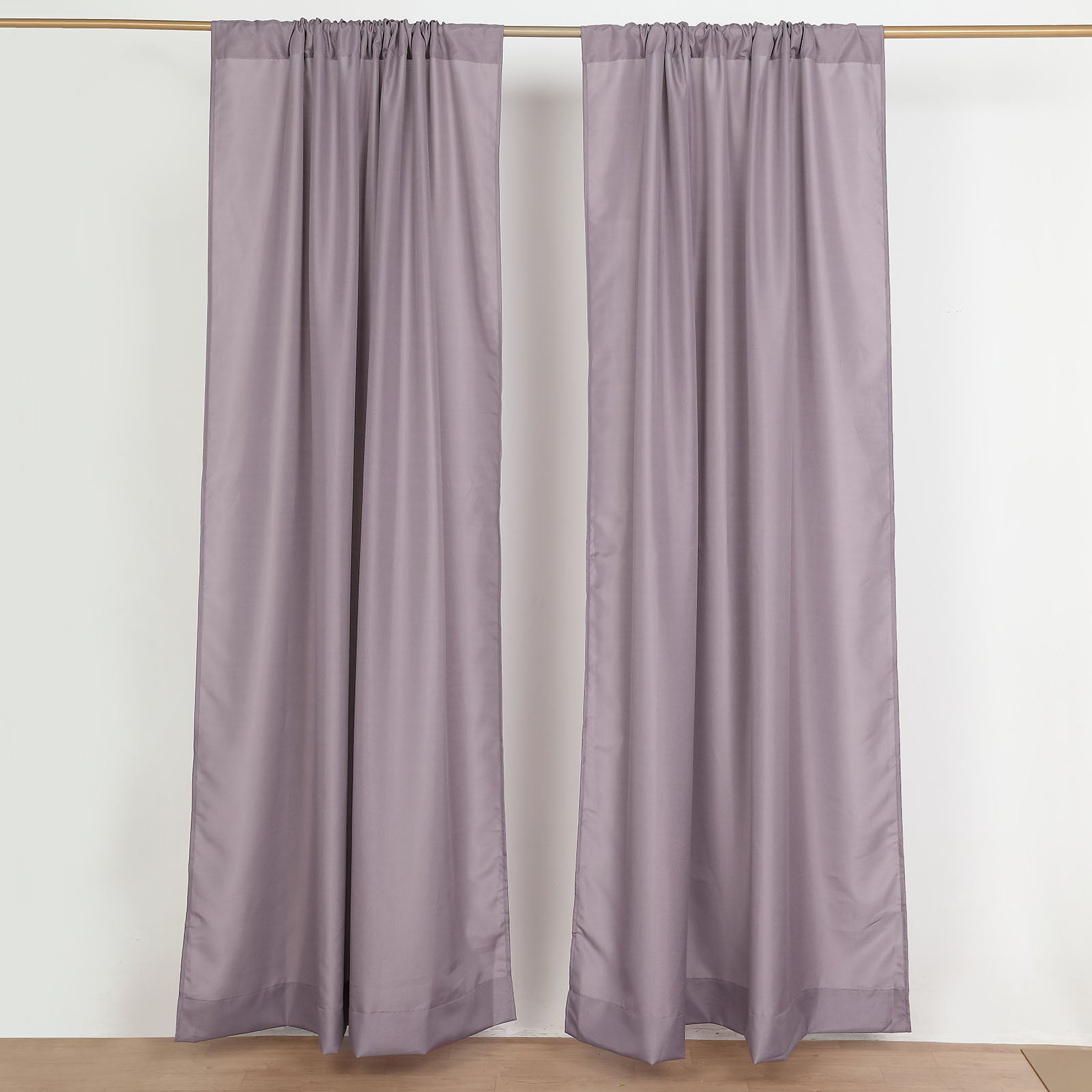 Violet amethyst polyester backdrop drape curtains with rod pockets.