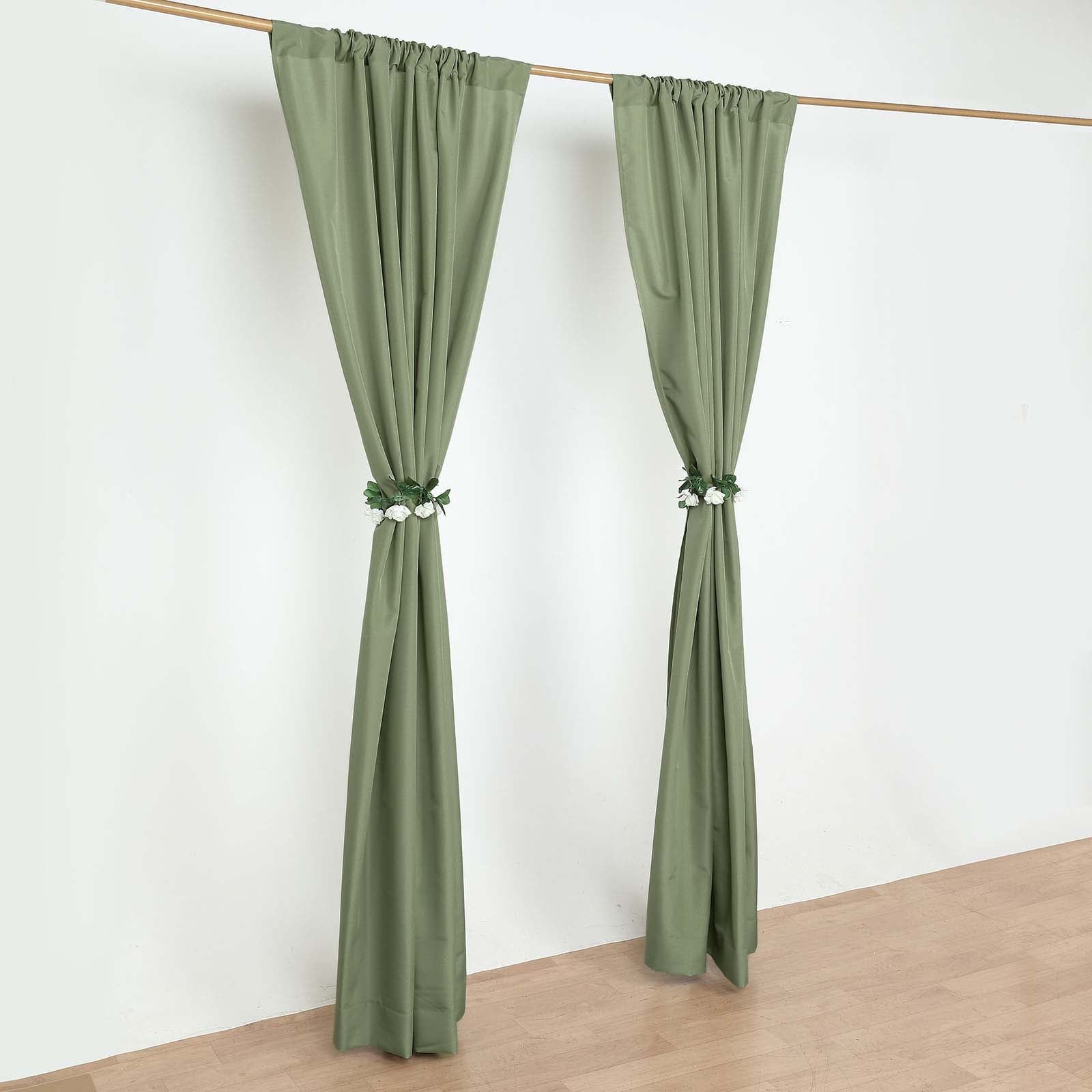 Dusty sage green polyester backdrop drape curtains on a rod.