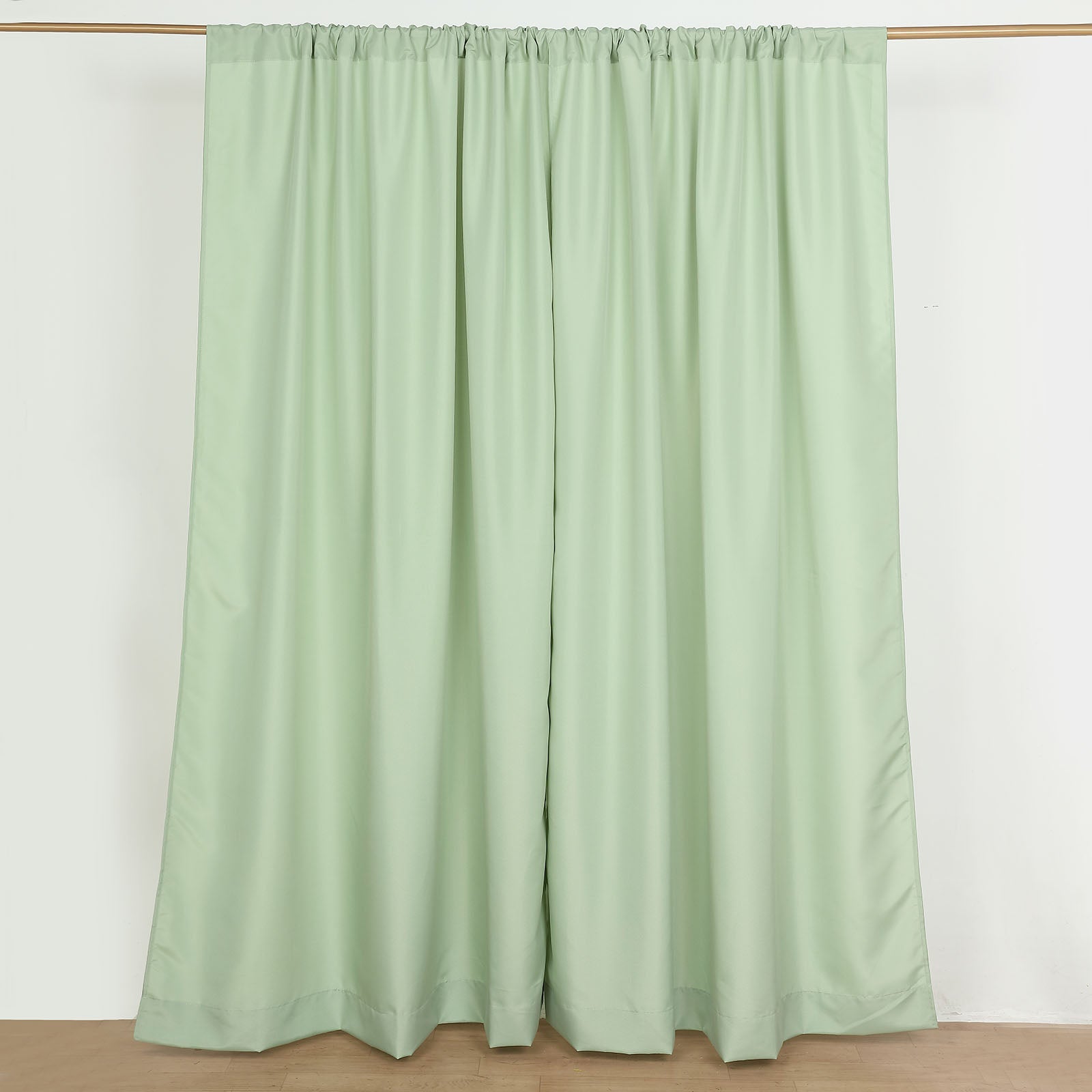Sage green polyester backdrop drape curtains with rod pockets.