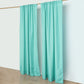 Turquoise polyester backdrop drape curtains on a rod.