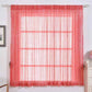Coral sequin curtains with rod pocket window treatment panels.