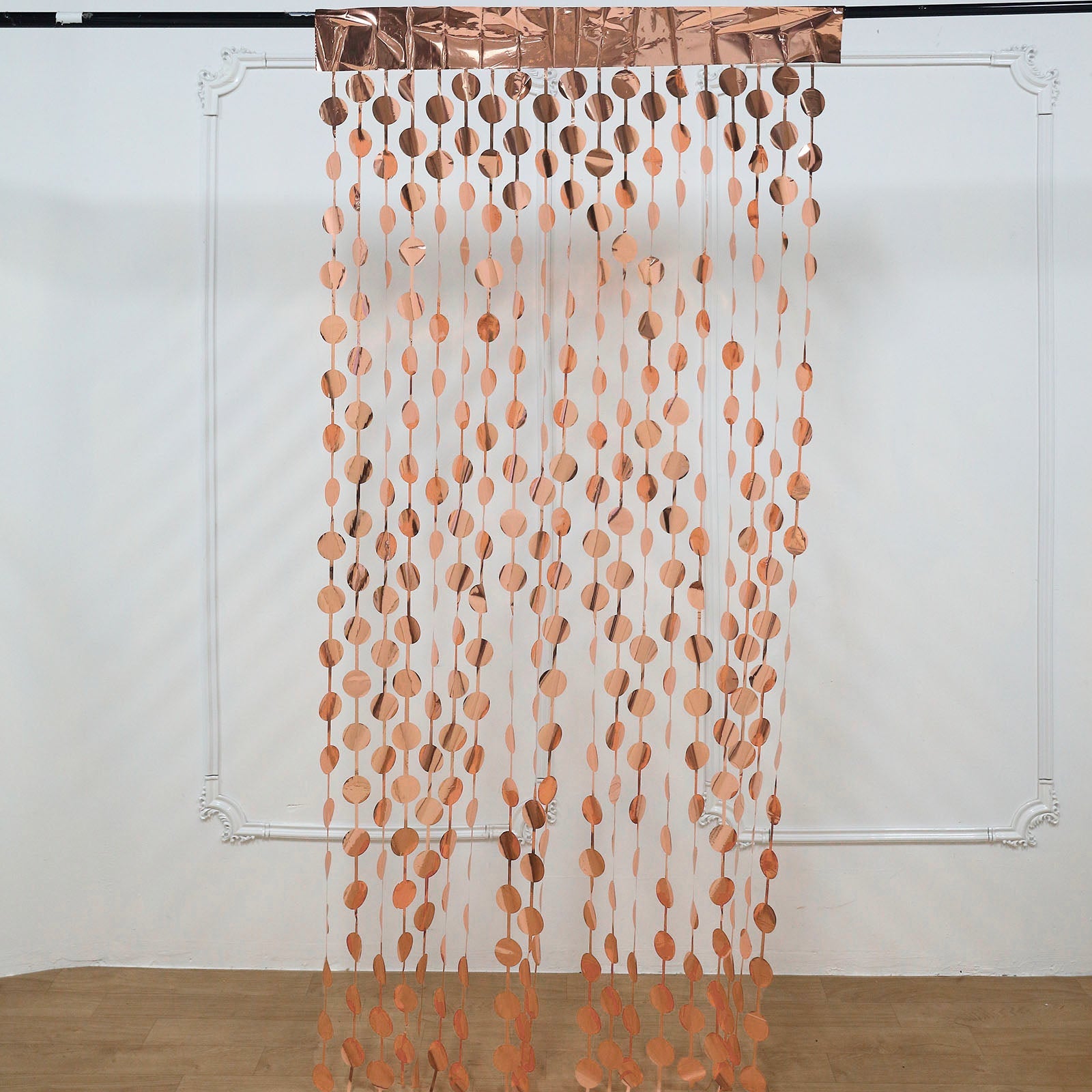 Rose gold foil fringe curtain backdrop for party decor.