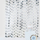 Silver foil fringe curtain backdrop for party decor.