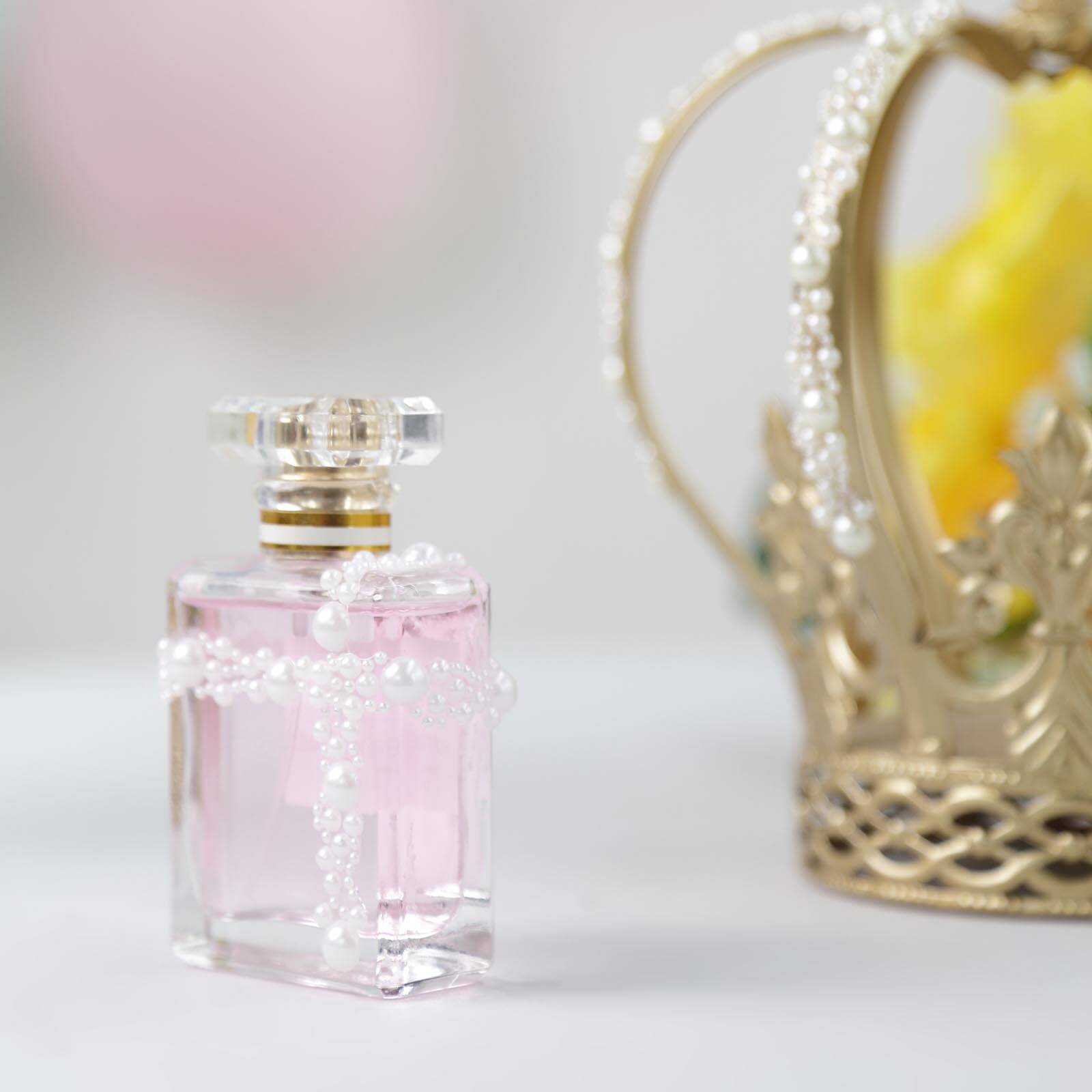 Ivory pearl rhinestone stickers on a decorative perfume bottle.
