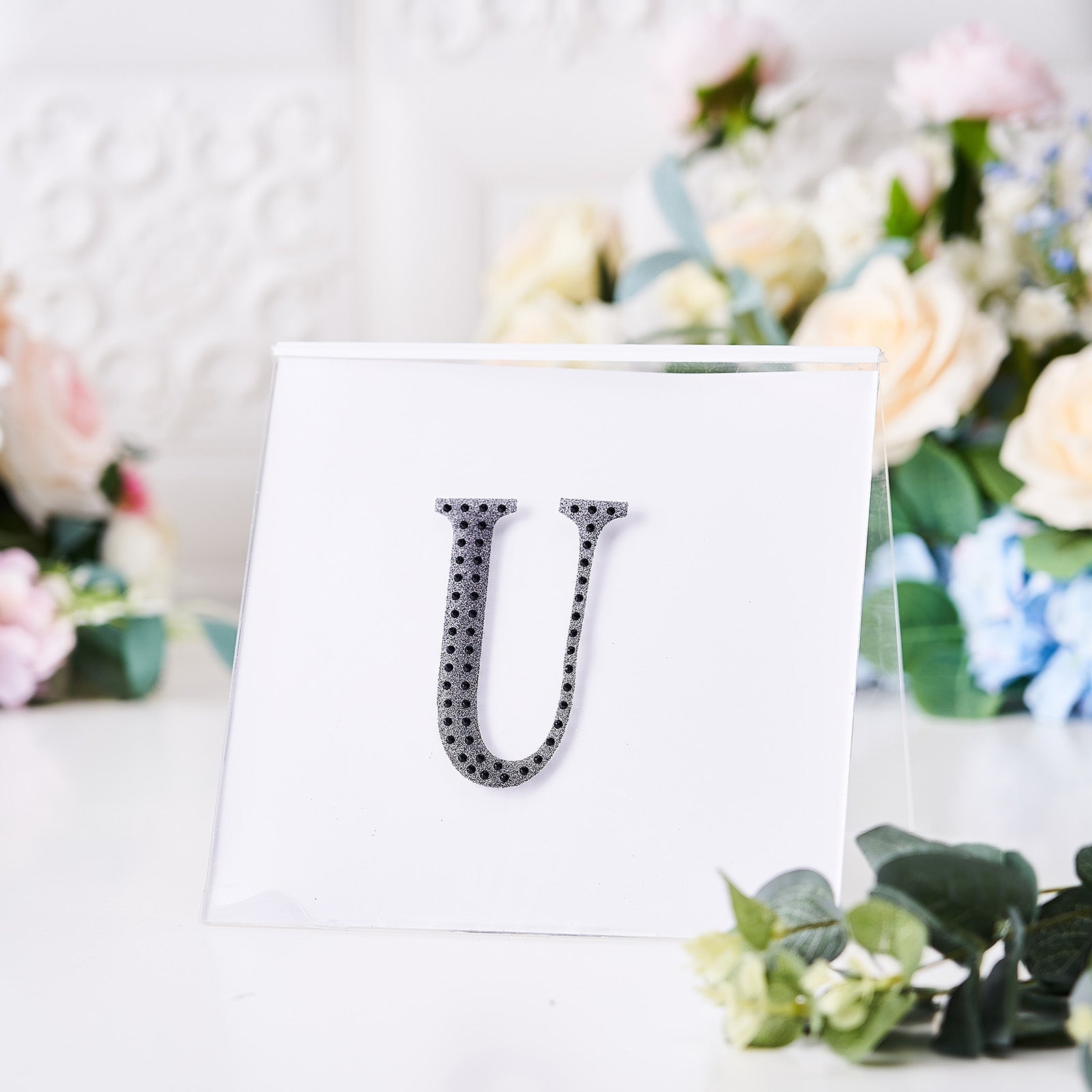 Black rhinestone letter "U" sticker for DIY crafts.