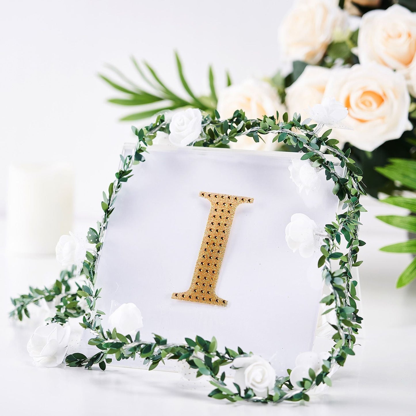 Gold rhinestone letter "I" sticker on a floral arrangement.