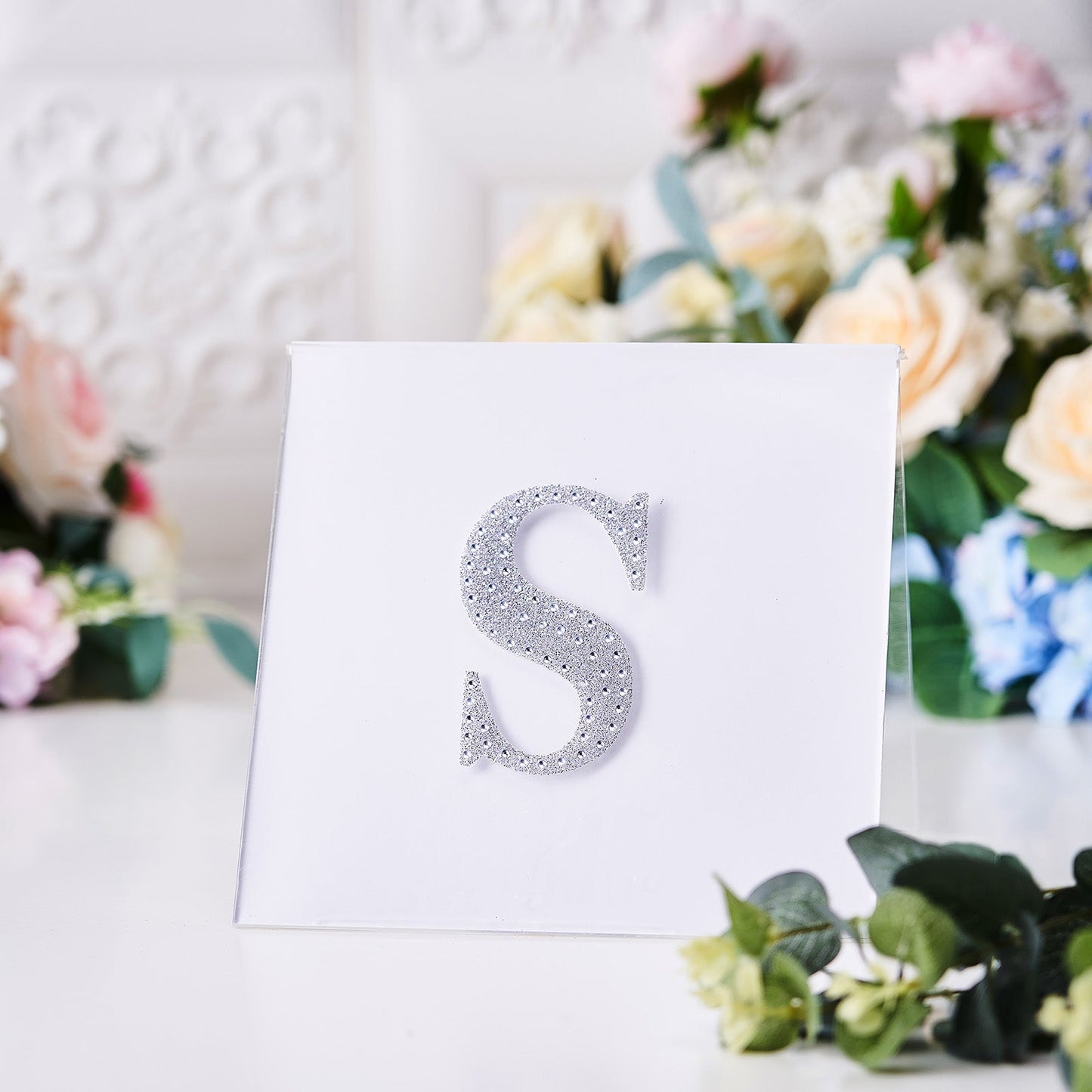 Silver decorative rhinestone letter "S" sticker on a white background.