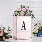 Black rhinestone letter "A" decorative sticker on a floral arrangement.