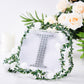 Silver decorative rhinestone letter "I" on a white background with greenery and flowers.