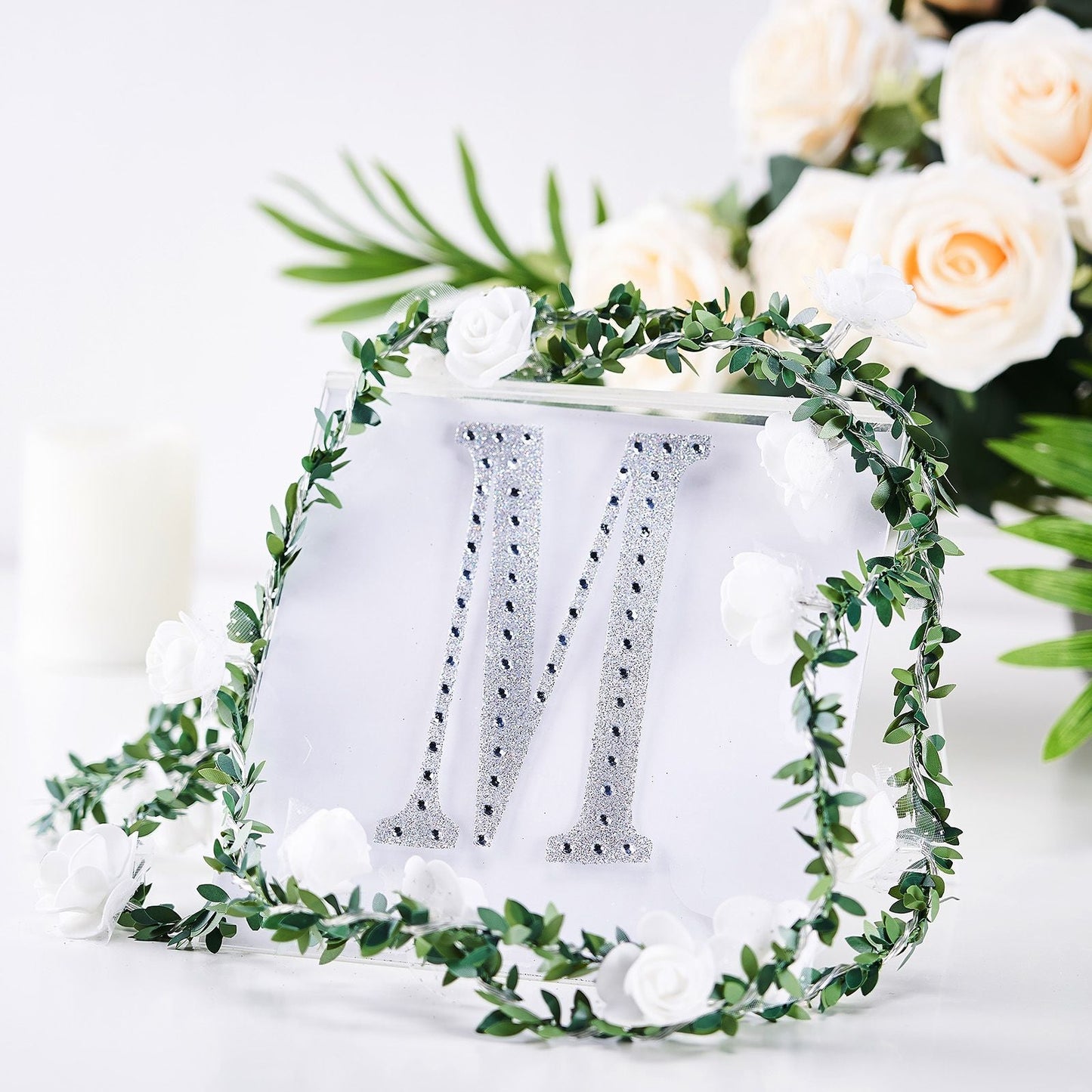 Silver decorative rhinestone letter "M" for DIY crafts.