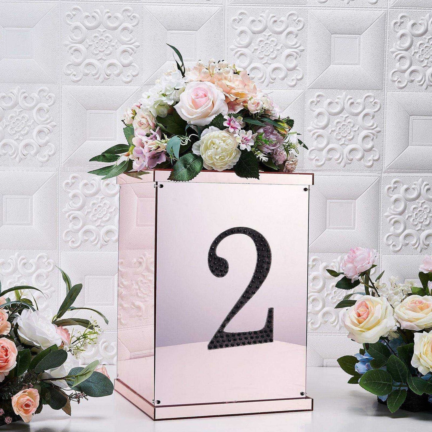 Black decorative rhinestone number "2" sticker on a decorative box with flowers.