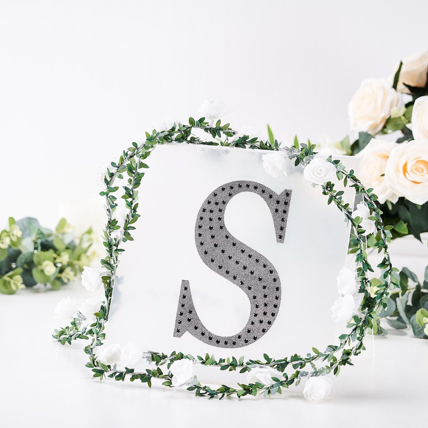 Black decorative rhinestone letter sticker "S" with floral accents.